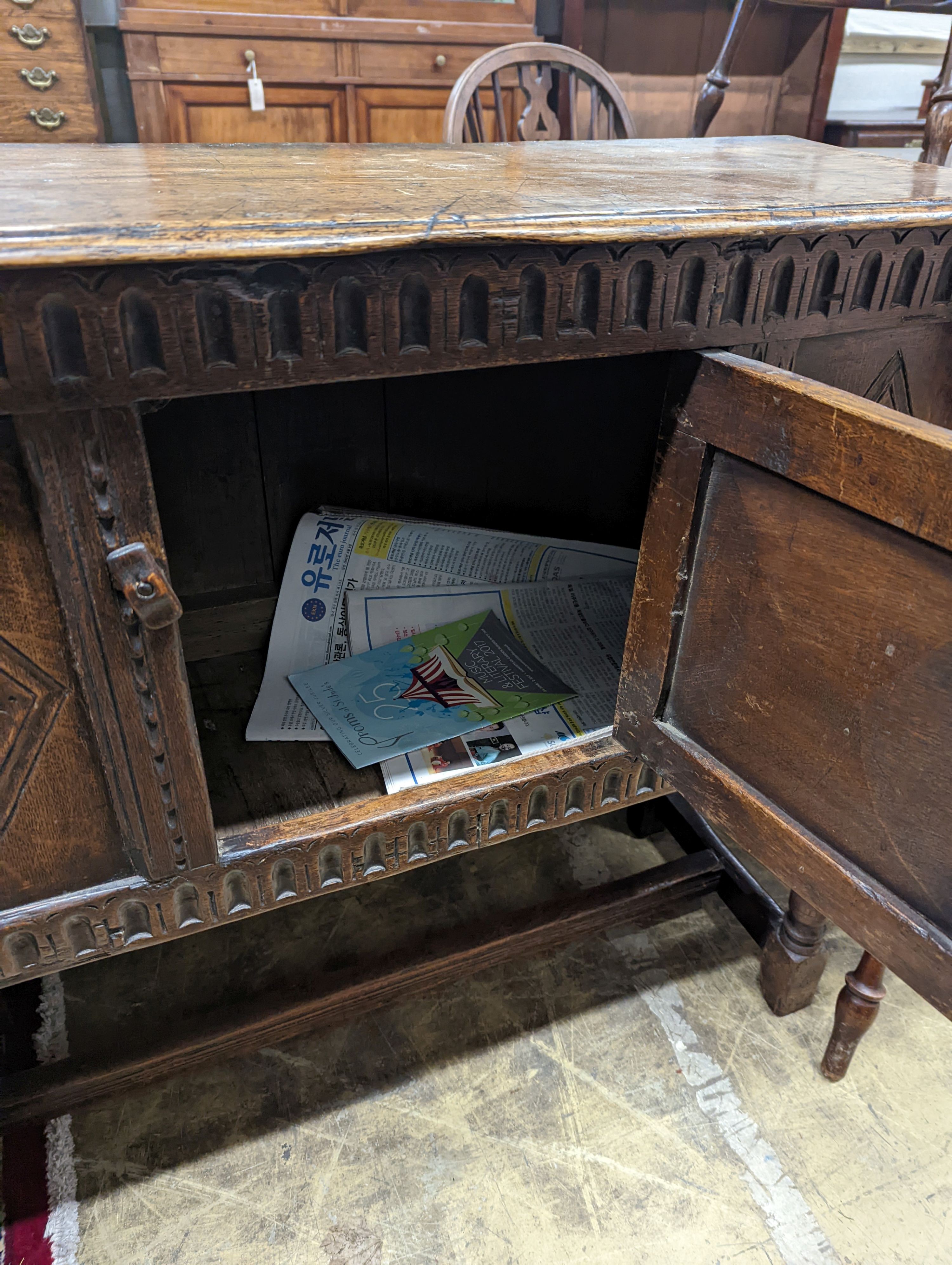 An 18th century style carved oak side cabinet, width 90cm, depth 35cm, height 83cm